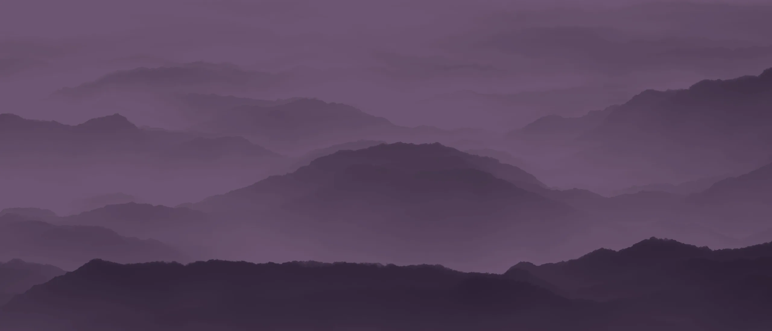 Mountain ridges fading into fog